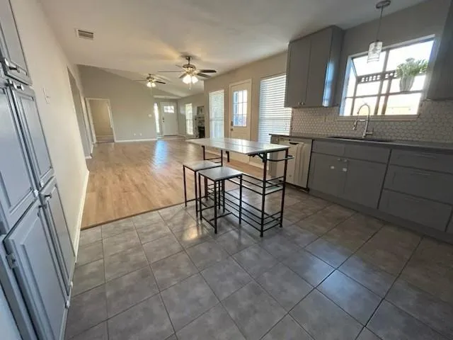 a kitchen with stainless steel appliances a refrigerator and a stove top oven