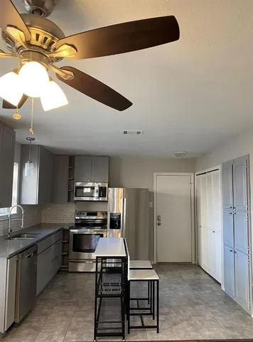 a view of a hallway with wooden floor and stairs