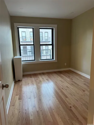 a kitchen with stainless steel appliances white cabinets and wooden floor