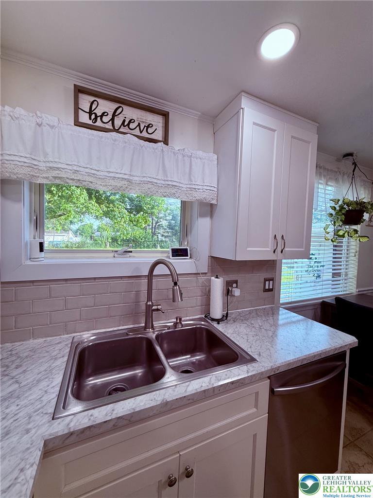 1275 Macada Road Bethlehem, PA 18017 - Photo 28 of 87 A pristine double sink and modern dishwasher complement the well-lit kitchen space.