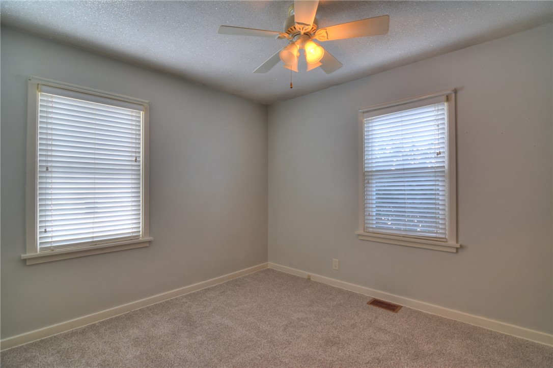 47 1st South Shores Avenue Decatur, IL 62521 - Photo 7 of 24 an empty room with a window and a fan