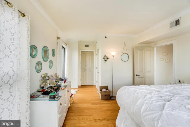 a bedroom with a bed and a potted plant