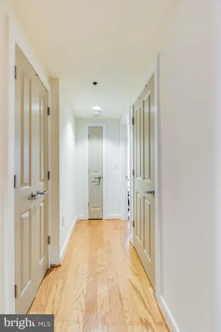 a view of a bedroom with wooden floor and bathroom