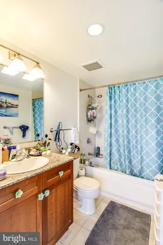 a bathroom with a sink a toilet and shower curtain