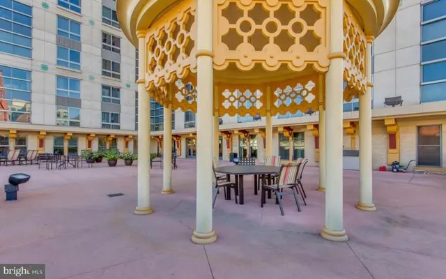 a view of a hall with a dining table and chairs