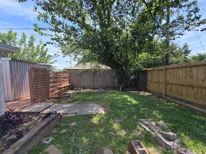 1110 Greencroft Street Channelview, TX 77530 - Photo 22 of 24 a view of backyard with wooden fence and a large tree