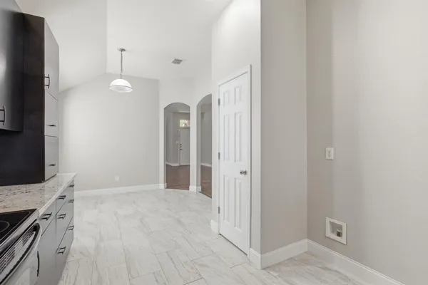 a view of a kitchen with a sink and a refrigerator