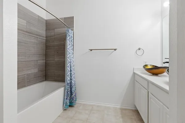a bathroom with a bathtub and a sink