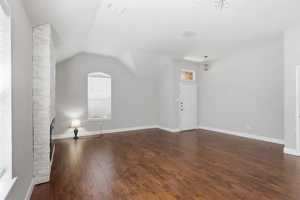 a view of a room with wooden floor