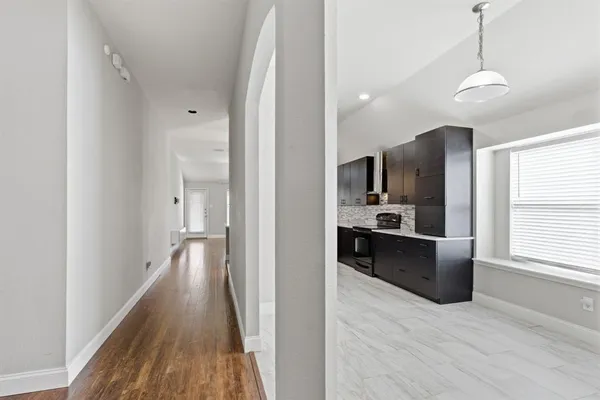 a view of kitchen with sink and refrigerator
