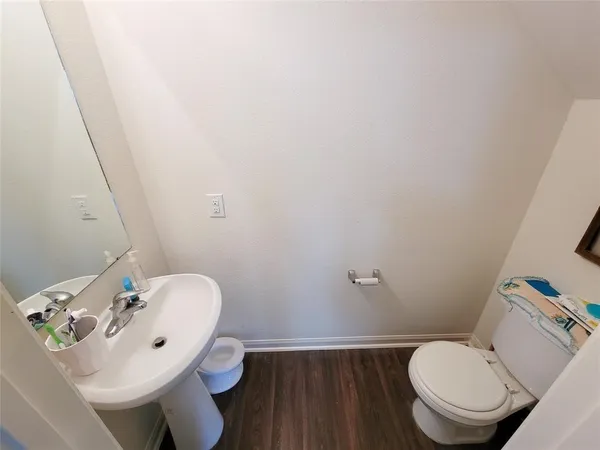 a bathroom with a sink mirror and toilet