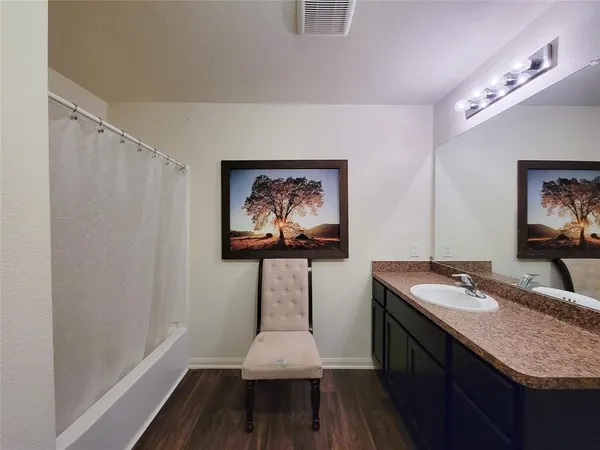 a bathroom with a granite countertop sink a mirror and vanity