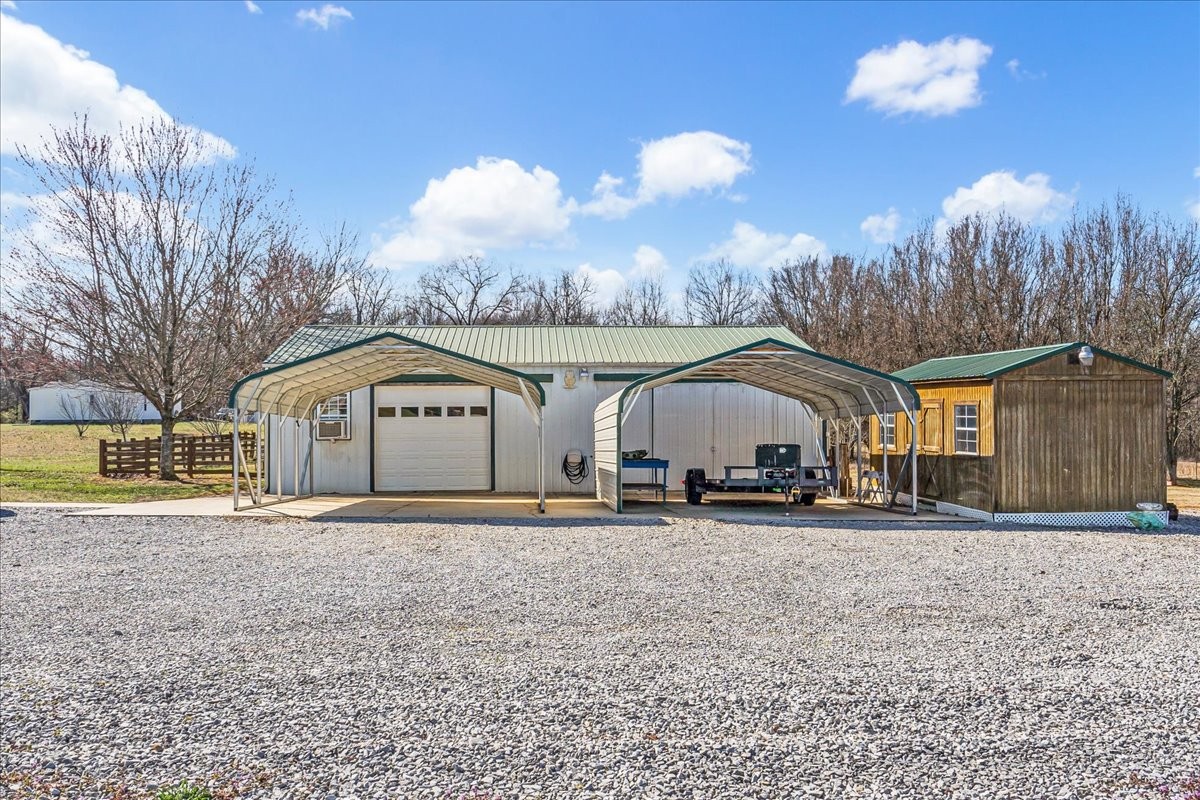 1175 Caney Branch Road Morrison, TN 37357 - Photo 47 of 52 a front view of a house with a yard and garage
