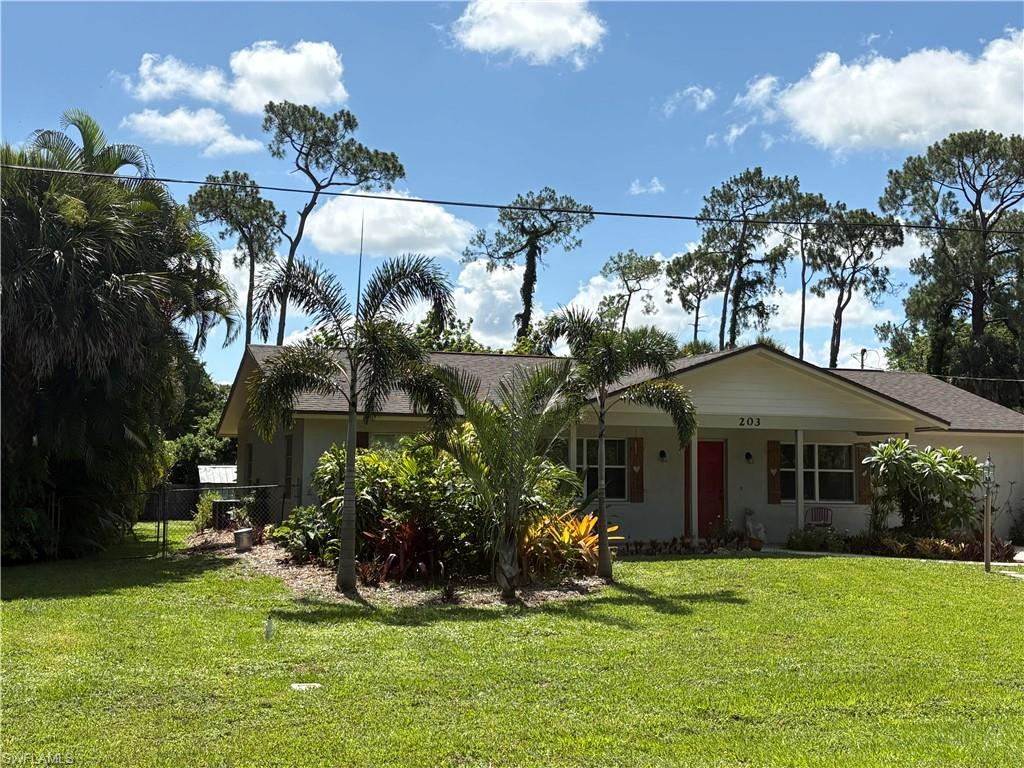 203 Esther Street Naples, FL 34104 - Photo 20 of 33 View of front of home with a porch, stucco siding, and roof with shingles