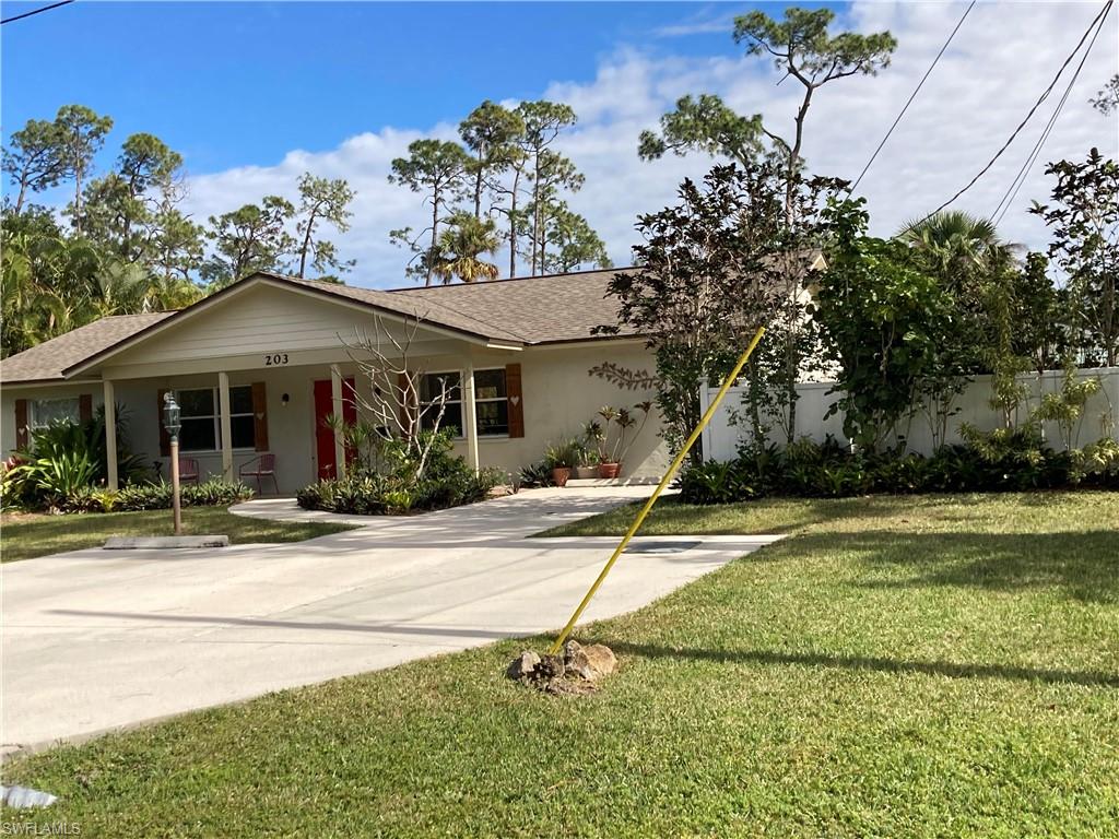 203 Esther Street Naples, FL 34104 - Photo 22 of 33 Single story home featuring covered porch, stucco siding, and a shingled roof