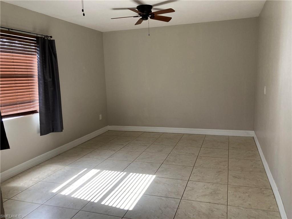 203 Esther Street Naples, FL 34104 - Photo 28 of 33 Empty room featuring a ceiling fan and light tile patterned flooring