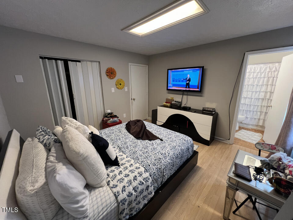 8300 Wynewood Court Raleigh, NC 27616 - Photo 27 of 51 a bedroom with bed and a couch