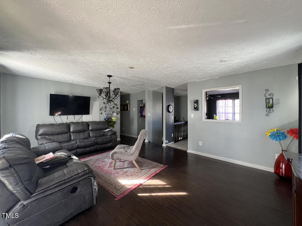8300 Wynewood Court Raleigh, NC 27616 - Photo 6 of 51 a living room with furniture and a flat screen tv