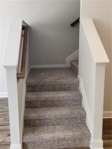 a view of staircase with white walls and a window