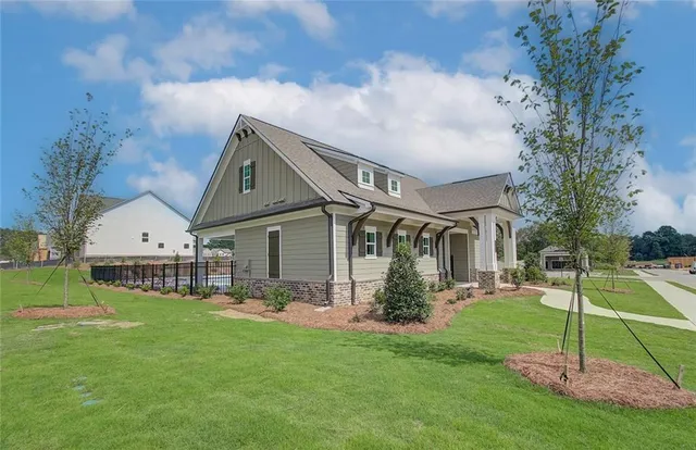 a front view of house with a garden and plants