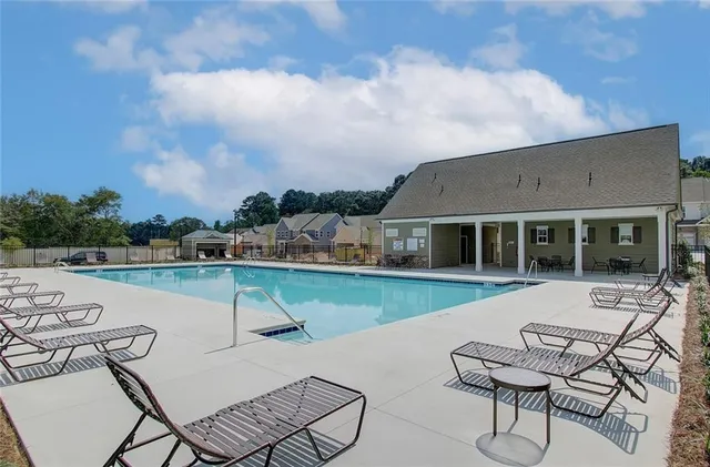 a view of a patio with table and chairs with wooden floor and fence