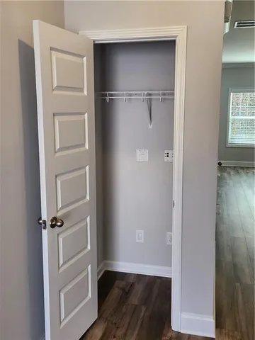 a view of walk in closet with empty racks