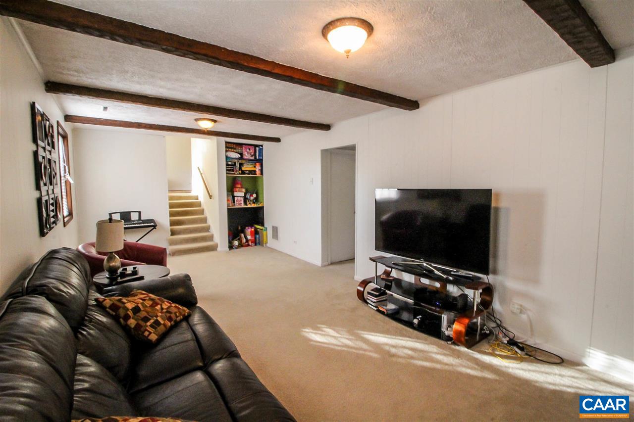 726 Shamrock Road Charlottesville, VA 22903 - Photo 18 of 27 a living room with furniture and a flat screen tv