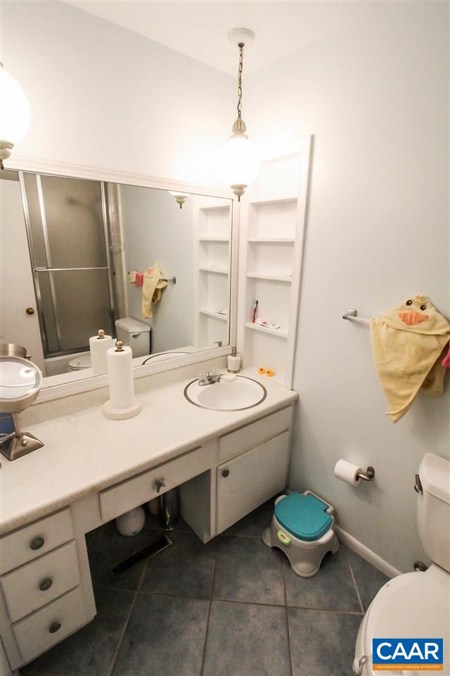726 Shamrock Road Charlottesville, VA 22903 - Photo 21 of 27 a bathroom with a double vanity sink toilet and a mirror