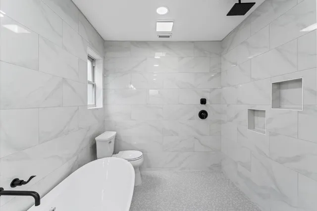 a bathroom with a toilet and shower