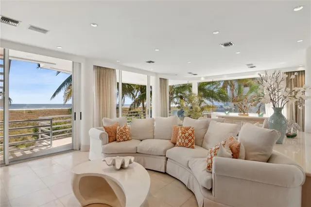 a living room with furniture potted plant and a table