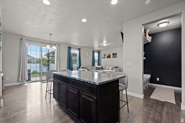 1074 South 750 West Springville, UT 84663 - Photo 12 of 28 Kitchen island featuring a granite-style countertop and dark wood cabinetry