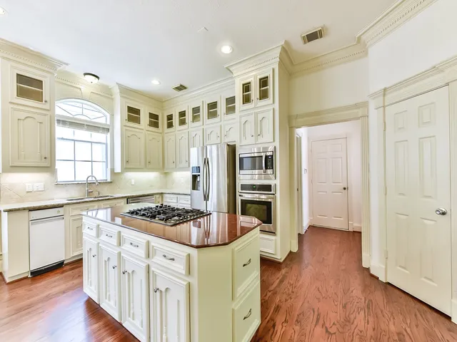 a kitchen with stainless steel appliances granite countertop a stove and a refrigerator