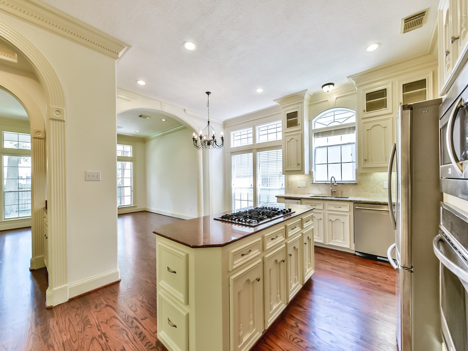 166 East Capstone Circle Spring, TX 77381 - Photo 16 of 45 a kitchen with stainless steel appliances granite countertop a sink stove and wooden floor