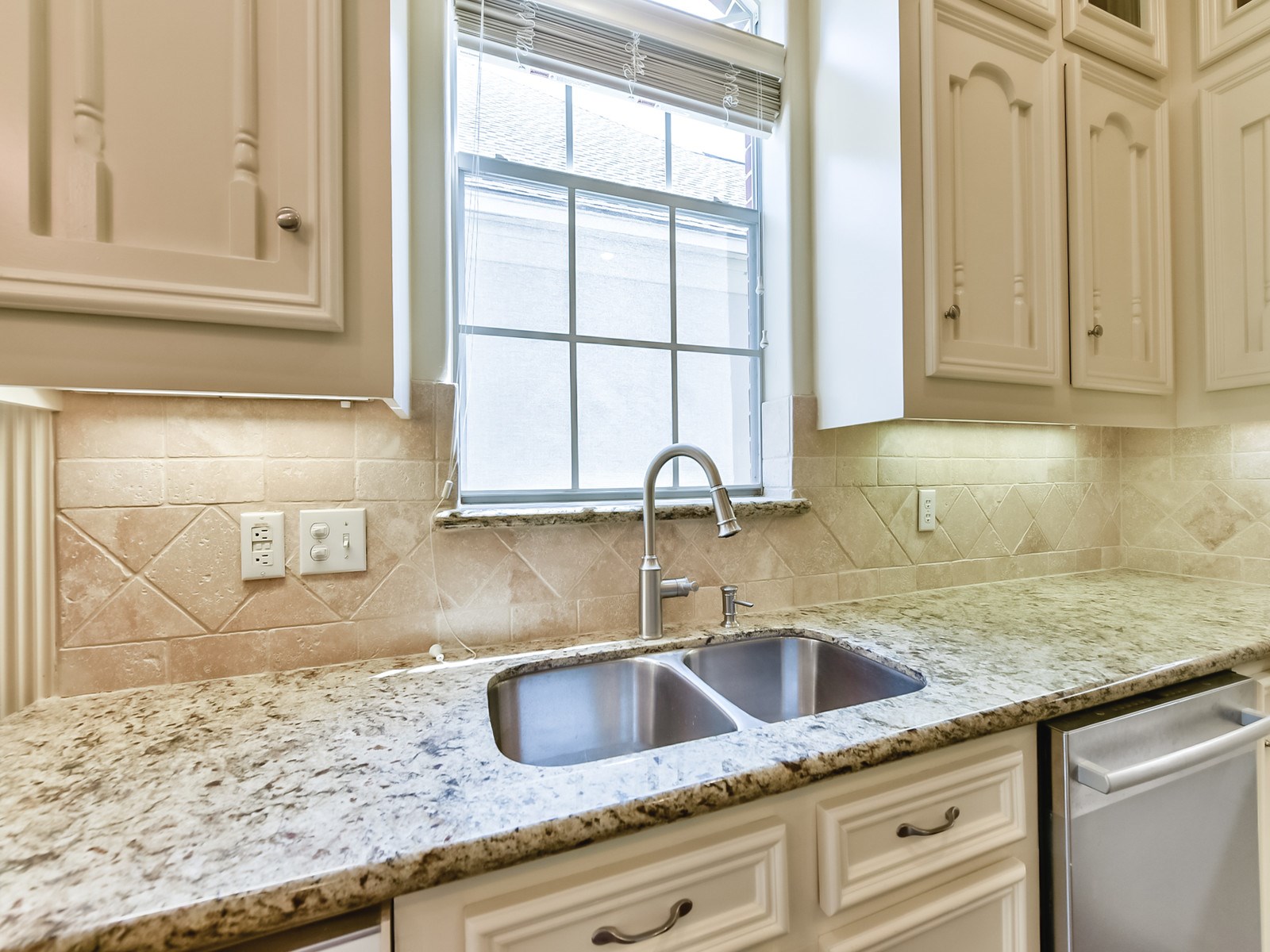 166 East Capstone Circle Spring, TX 77381 - Photo 17 of 45 a kitchen with granite countertop a sink and a window