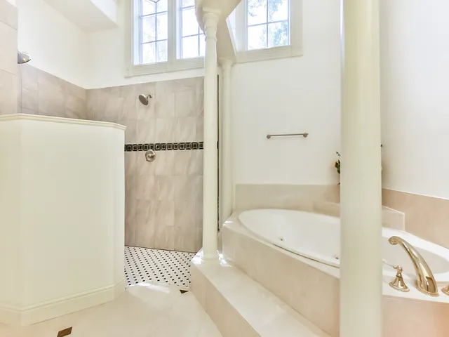 a spacious bathroom with a granite countertop sink mirror and shower