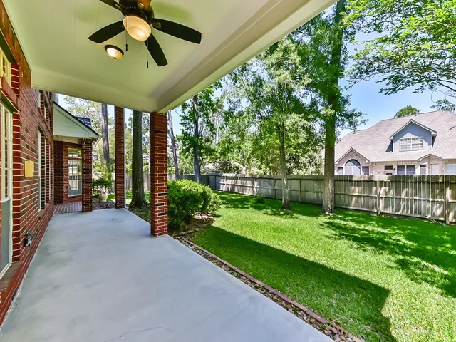 a view of a house with backyard and porch