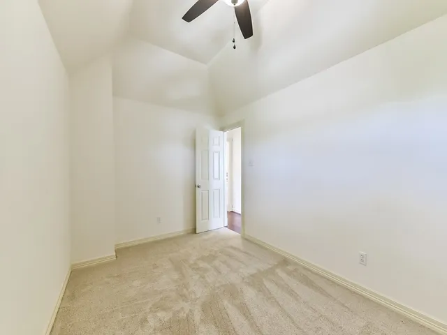 a bathroom with a granite countertop double vanity sink toilet and shower