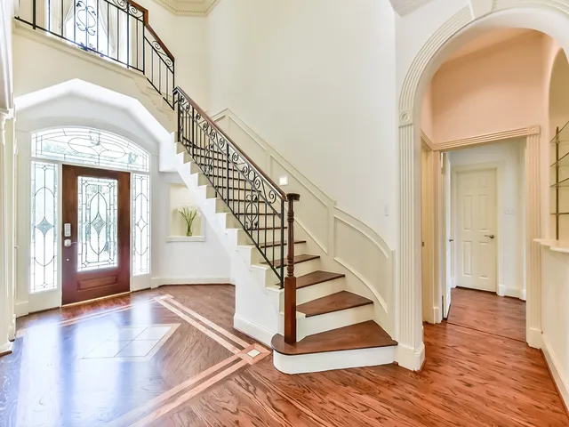 a view of entryway and hall with wooden floor