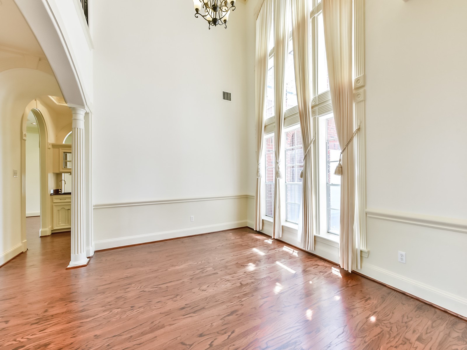 166 East Capstone Circle Spring, TX 77381 - Photo 10 of 45 an empty room with wooden floor and windows