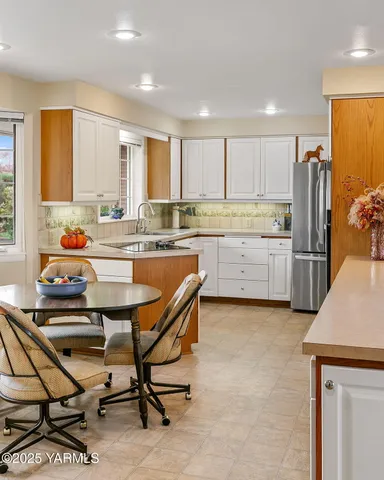 a kitchen with stainless steel appliances kitchen island granite countertop a sink and cabinets