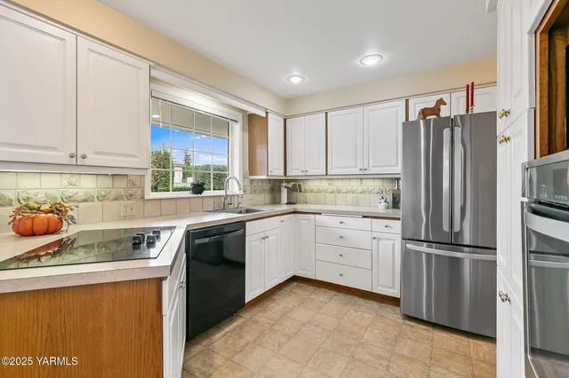 a kitchen with a refrigerator sink and cabinets