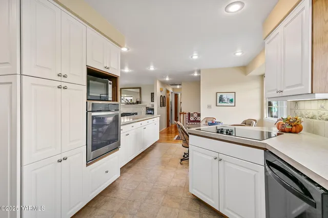 a kitchen with white cabinets and white appliances