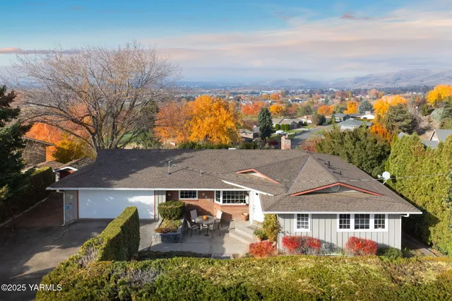 an aerial view of a house with garden space and wooden roof