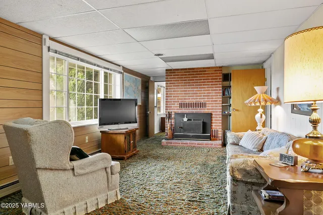 a living room with fireplace furniture and a flat screen tv