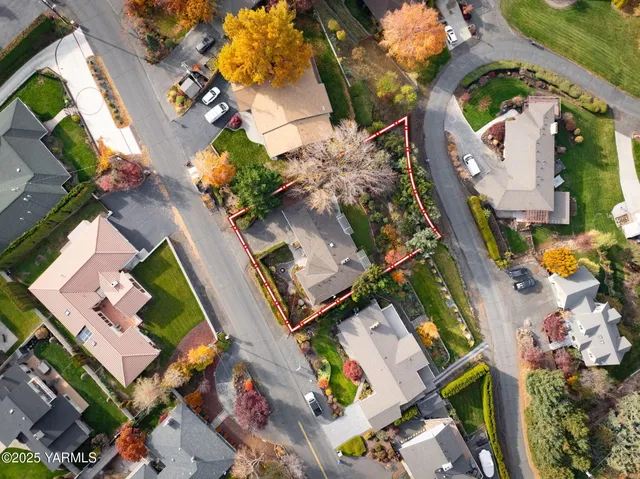 an aerial view of a house with a yard and swimming pool