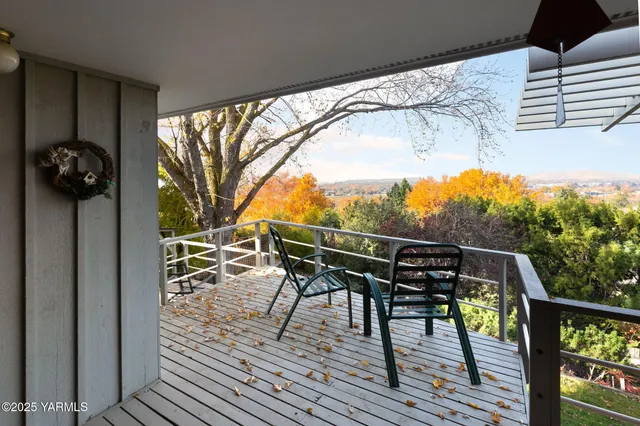 a view of balcony with wooden floor and outdoor seating