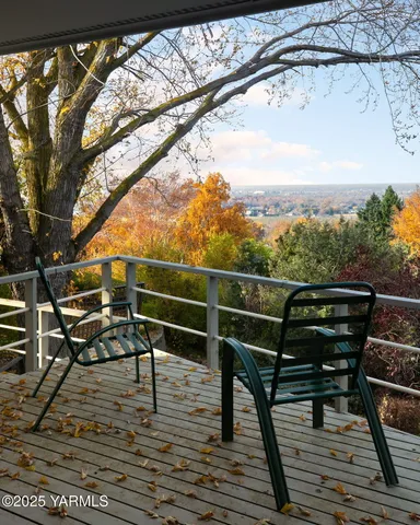 a view of a roof deck with wooden floor and seating space