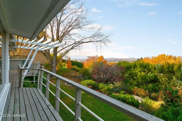 a view of balcony with wooden floor and fence