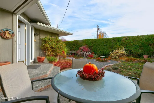 a view of a dining room with furniture and a floor to ceiling window