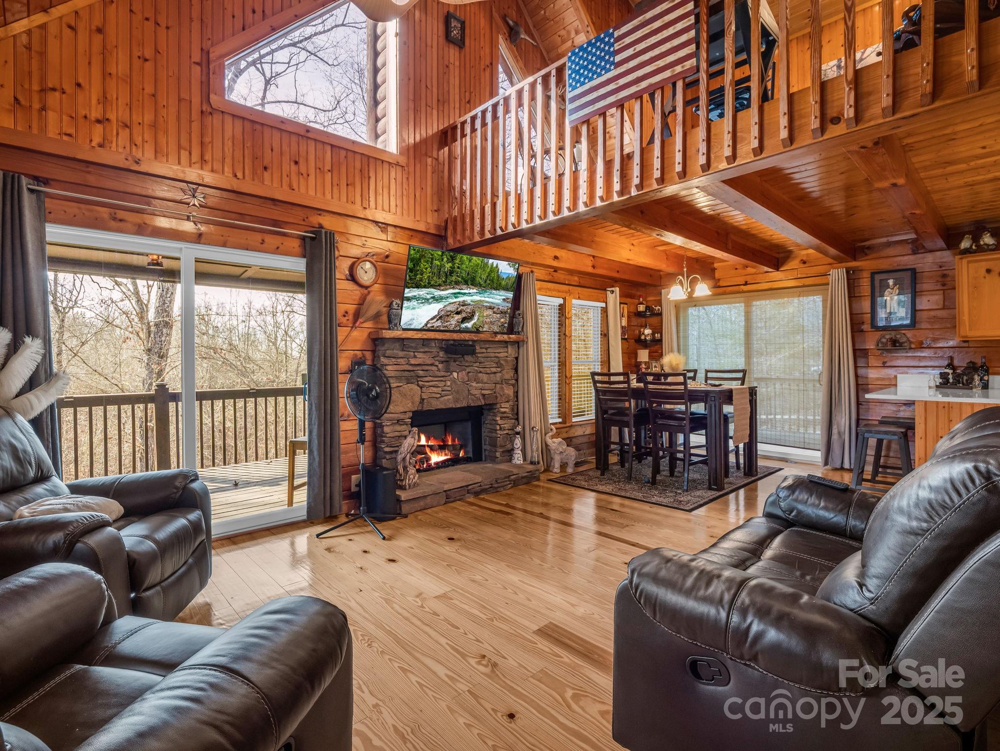 815 Cross Ridge Drive Rutherfordton, NC 28139 - Photo 17 of 34 a living room with furniture a fireplace and a large window